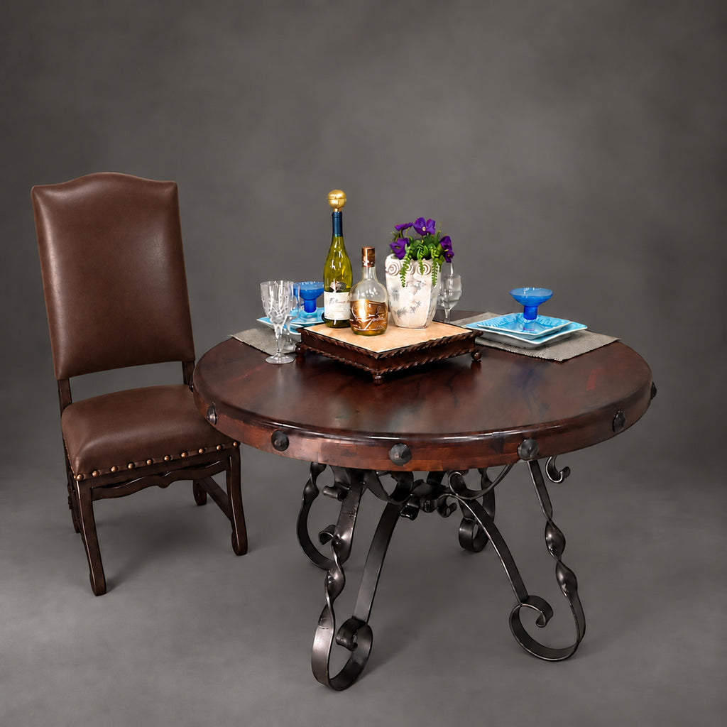 1212D round mesquite dining table with decorative hand-forged iron scroll base