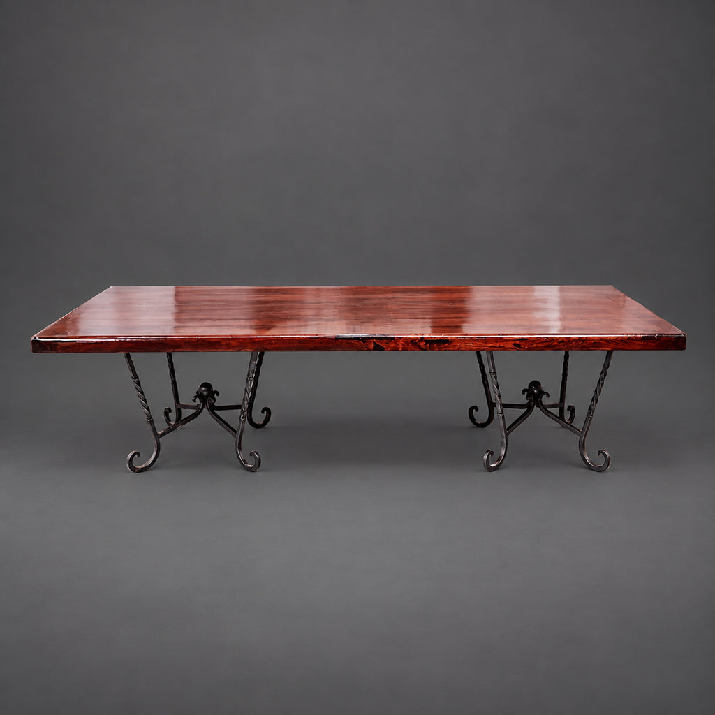 Mexports 1211RDM rectangular mesquite dining table with a brown wood top and two dark scrollwork pedestal bases.