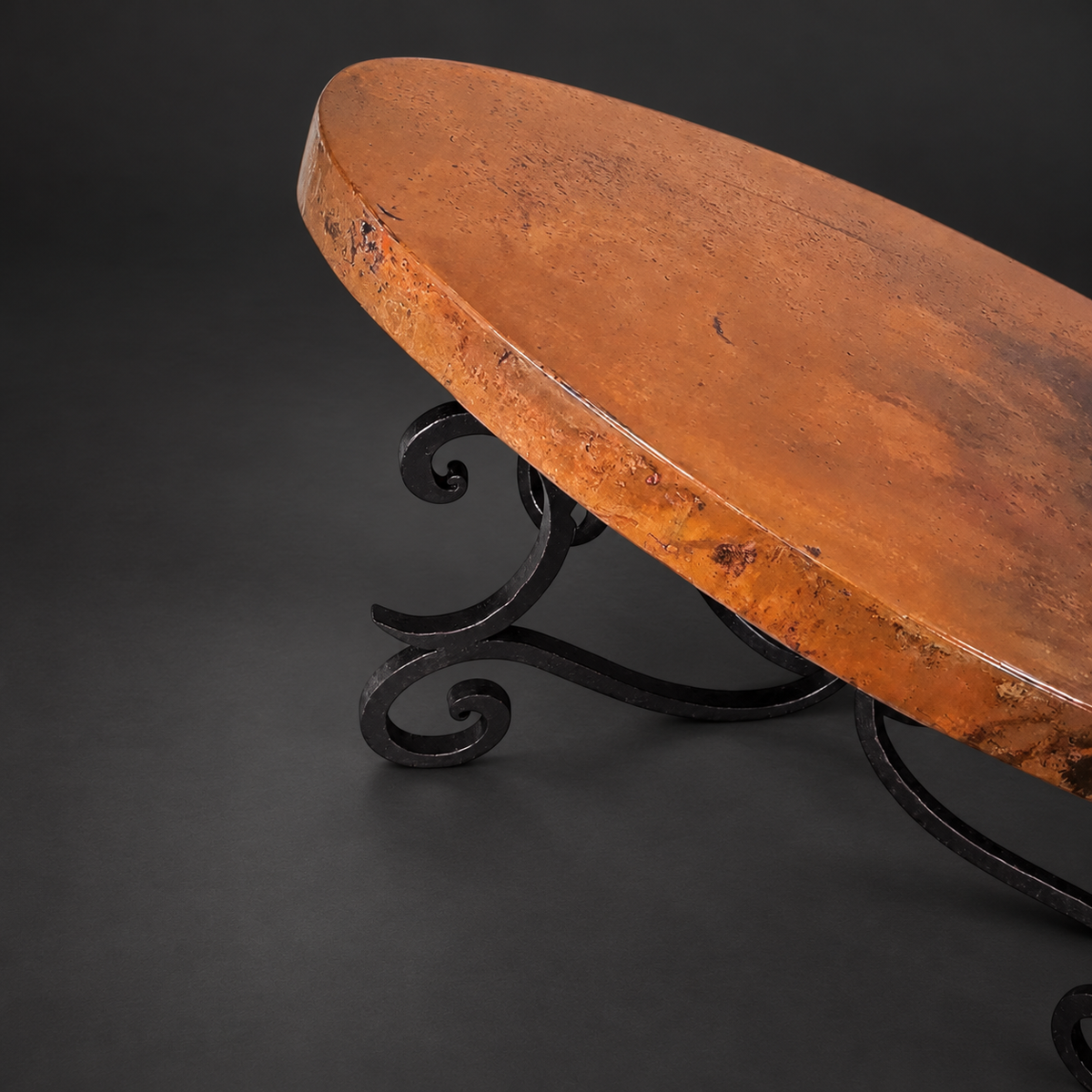 1215AA oval natural copper coffee table with hand-forged iron scroll base