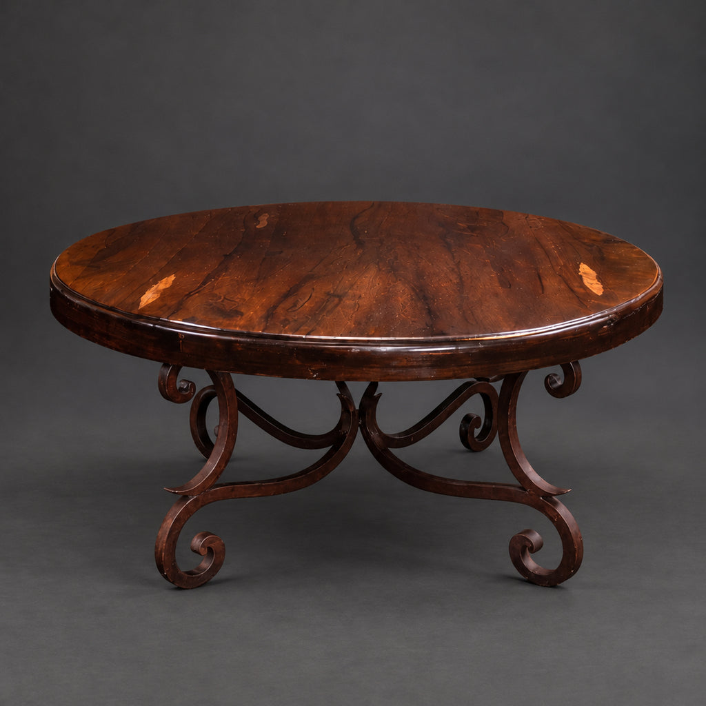 Round mesquite coffee table with a brown bullnose-edge top and dark reddish-brown iron scroll base with curled feet, model 1215 AAA.