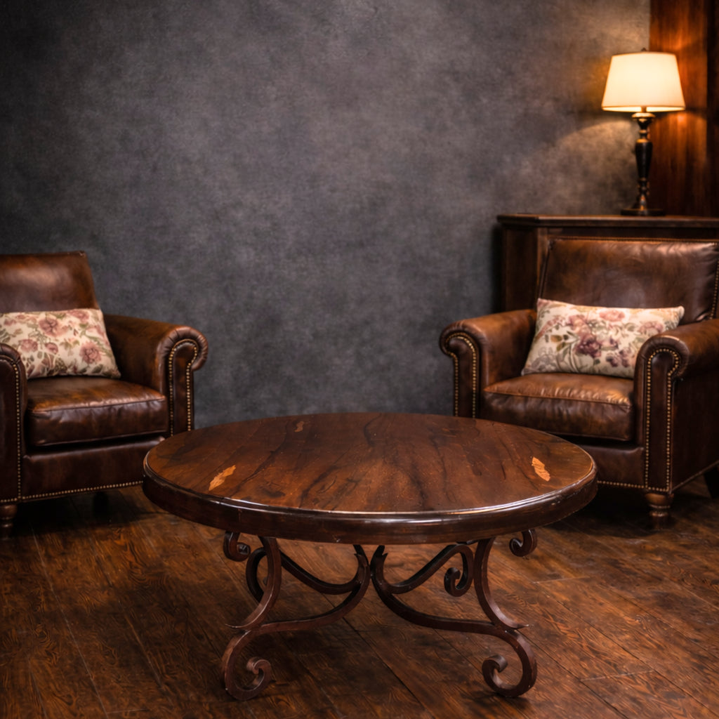 Round mesquite coffee table with a brown bullnose-edge top and dark reddish-brown iron scroll base with curled feet, model 1215 AAA.