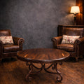 Round mesquite coffee table with a brown bullnose-edge top and dark reddish-brown iron scroll base with curled feet, model 1215 AAA.
